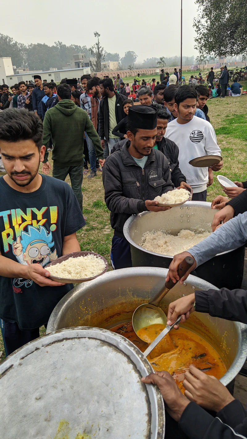Volunteers serving food at the Ambaji Seva Camp